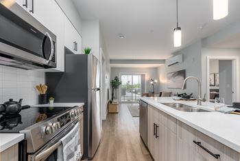 A modern kitchen with stainless steel appliances and wooden cabinets.